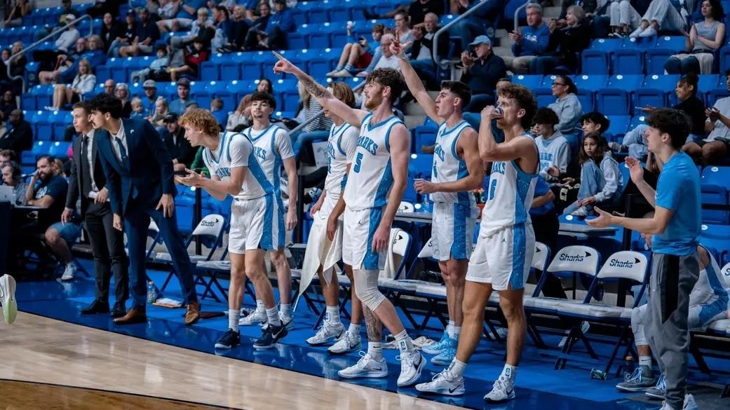 Nova Southeastern players celebrate on the sideline after another home victory.
