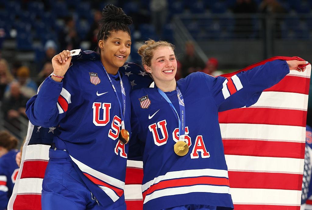Caroline Harvey and Wisconsin teammate Laila Edwards celebrate winning gold medals at the 2026 Winter Olympics